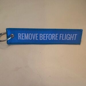 Blue Keychain with 'Remove Before Flight' Tag
